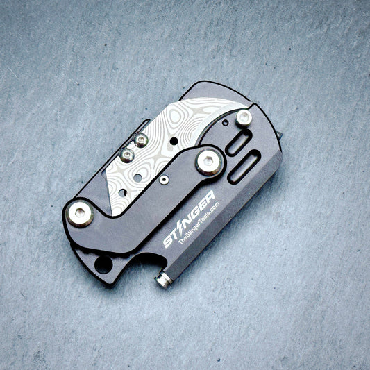 Stinger Dog Tag Tool — pocket clip and lanyard hole detail