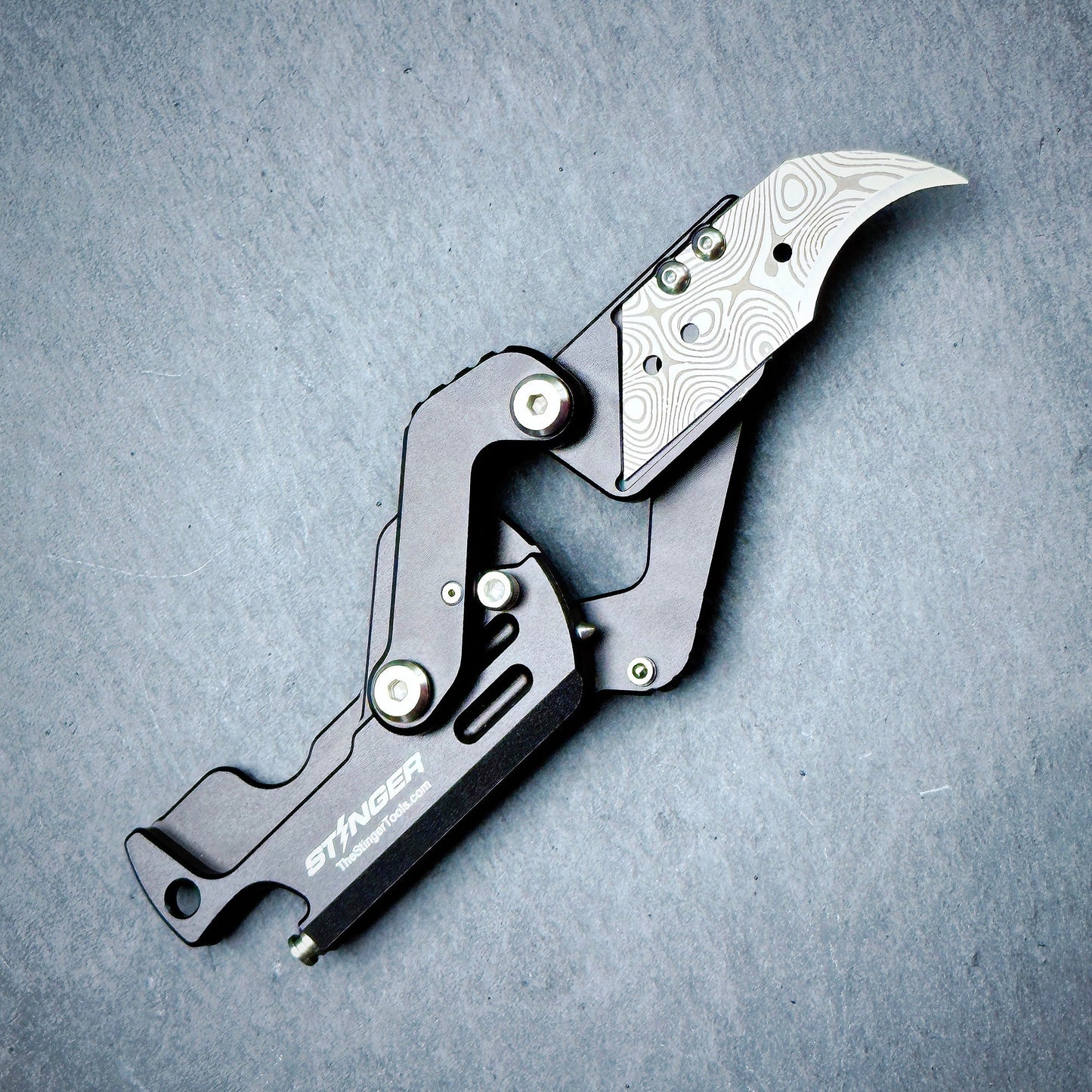 Stinger Dog Tag Tool matte black — folding blade deployed