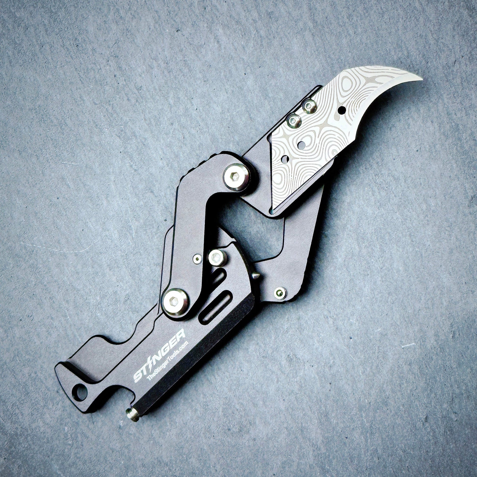 Stinger Dog Tag Tool matte black — folding blade deployed