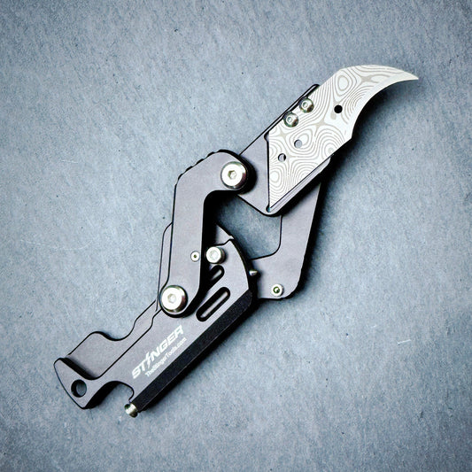 Stinger Dog Tag Tool matte black — folding blade deployed