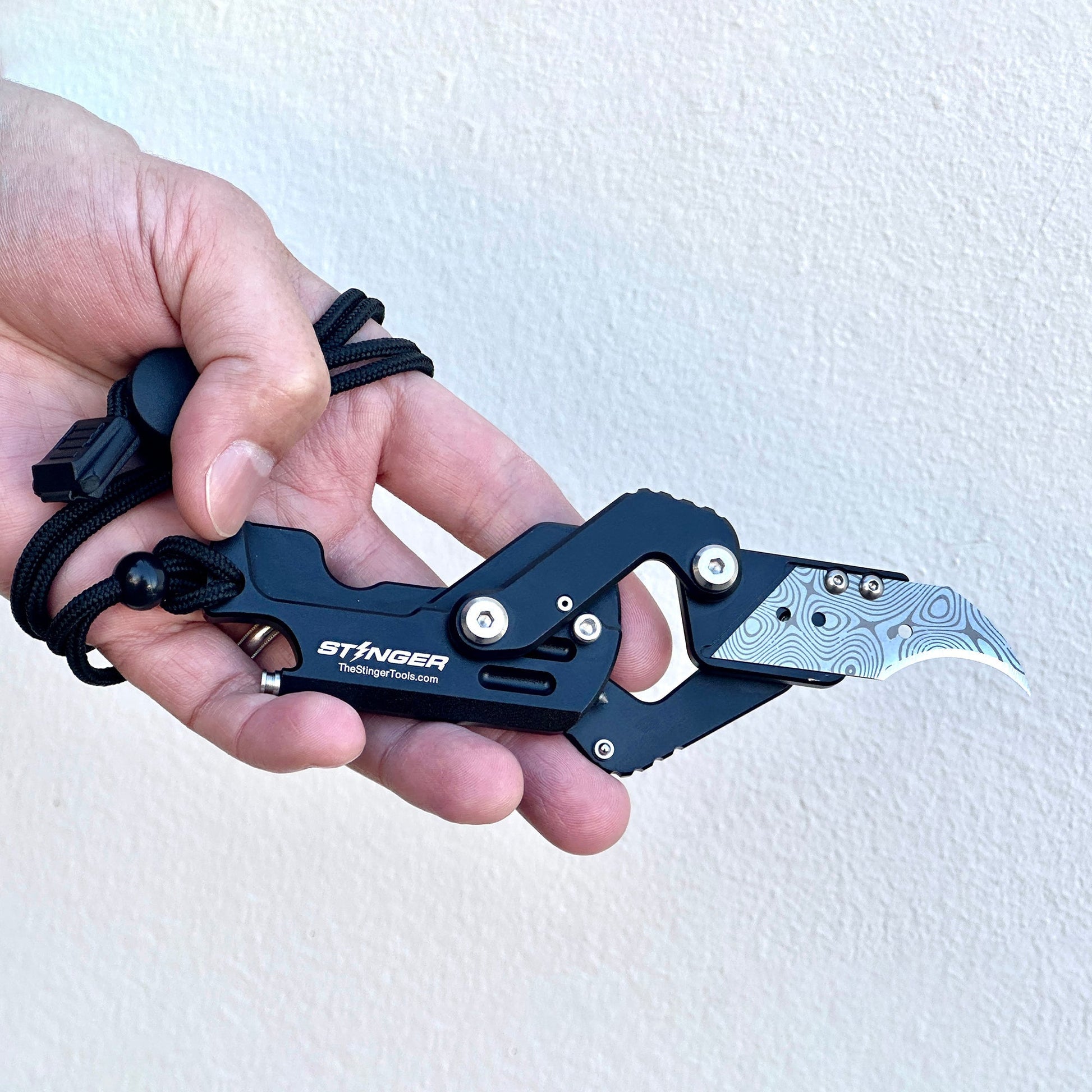 Stinger Dog Tag Tool — in-hand cutting demonstration