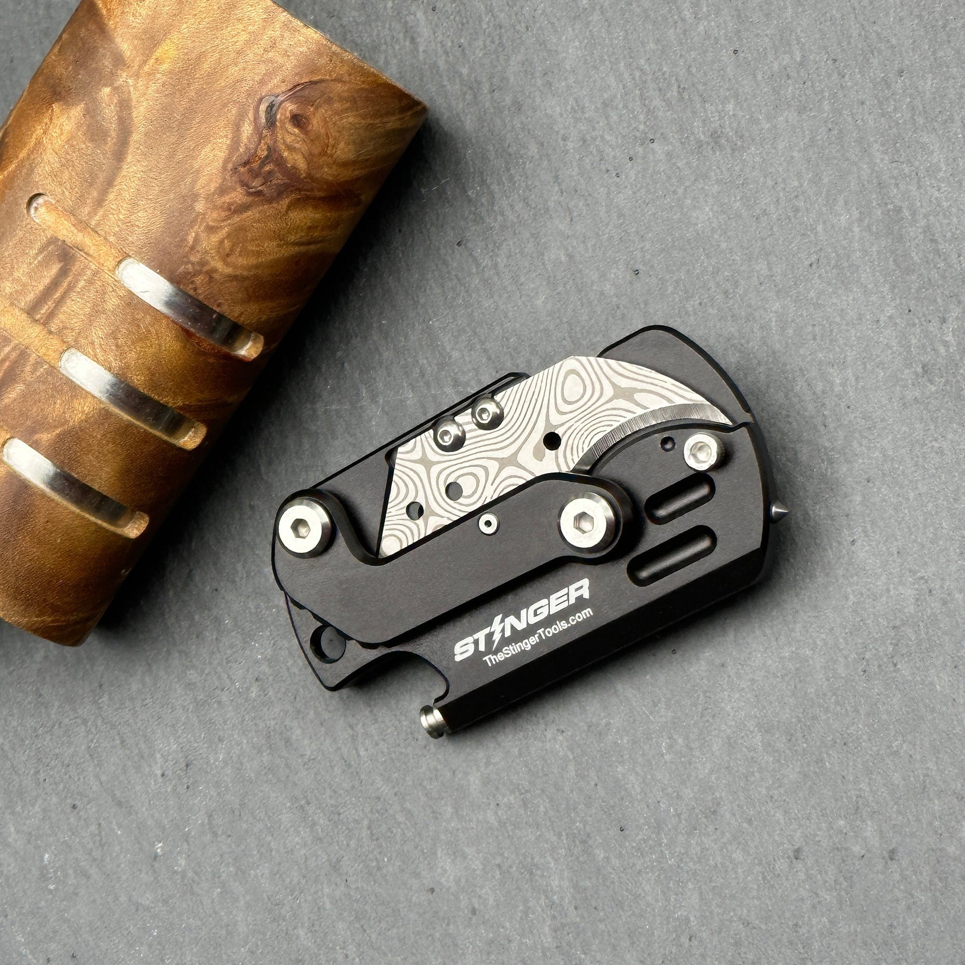 Stinger Dog Tag Tool — folding mechanism close-up