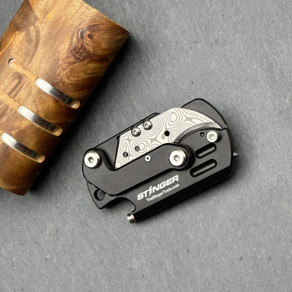 Stinger Dog Tag Tool — folding mechanism close-up